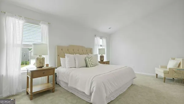 a bedroom with a bed and a chair