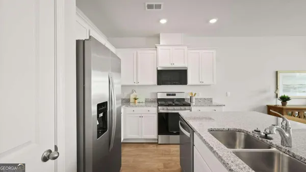 a kitchen with a sink microwave and refrigerator
