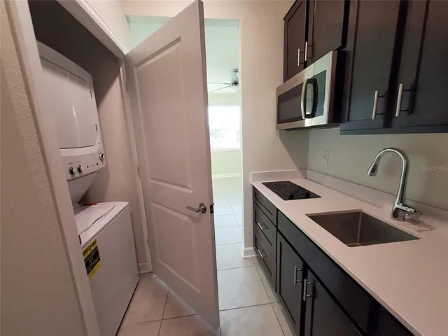 a utility room with sink washer and dryer
