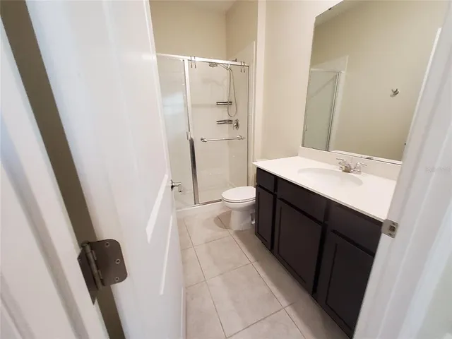 an empty room with wooden floor and door