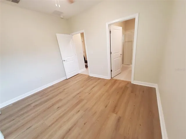a view of a room with wooden floor and staircase