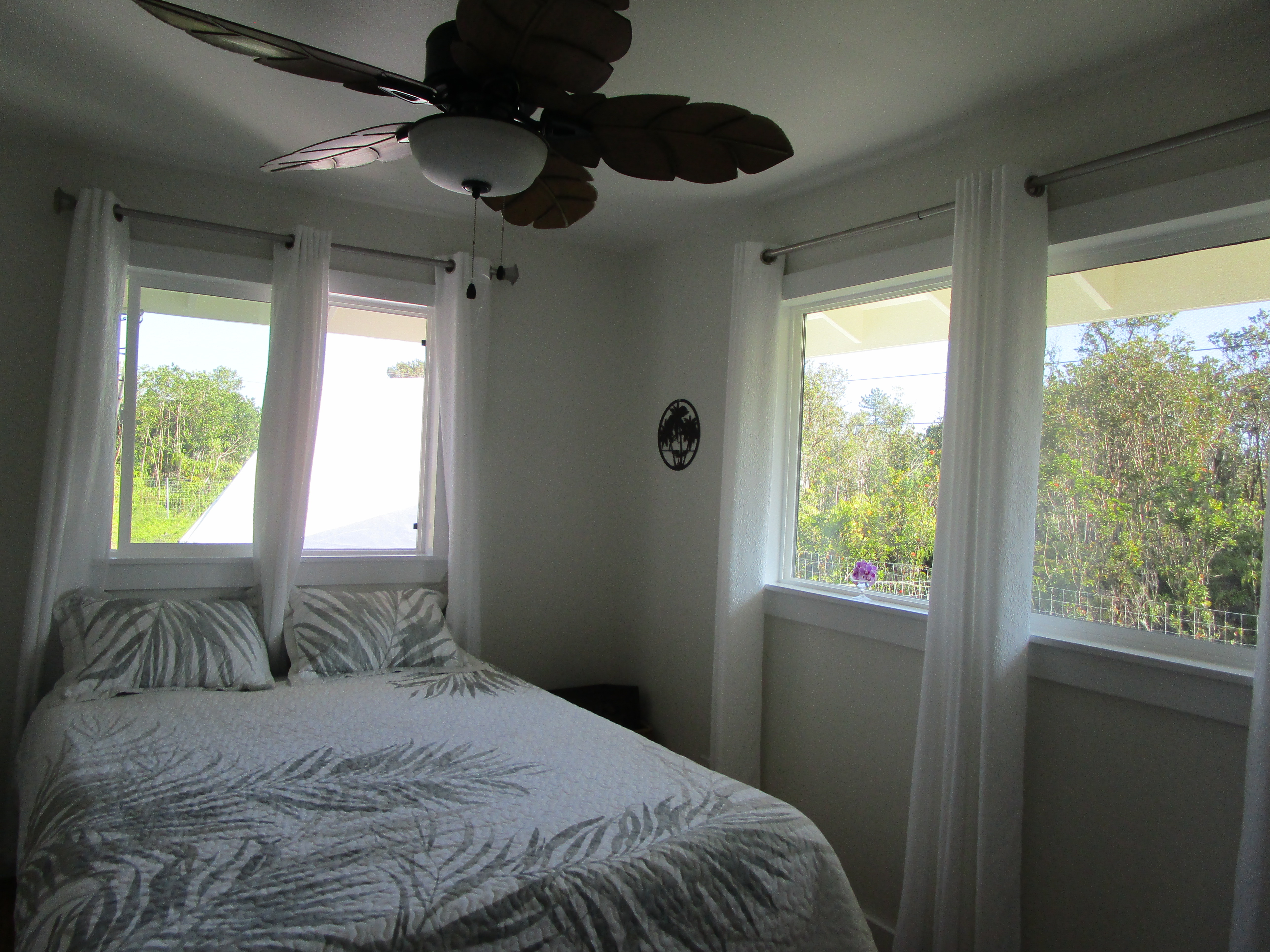 1 Kokokahi Road Mountain View, HI 96771 - Photo 11 of 27 a bedroom with a large bed and a large window