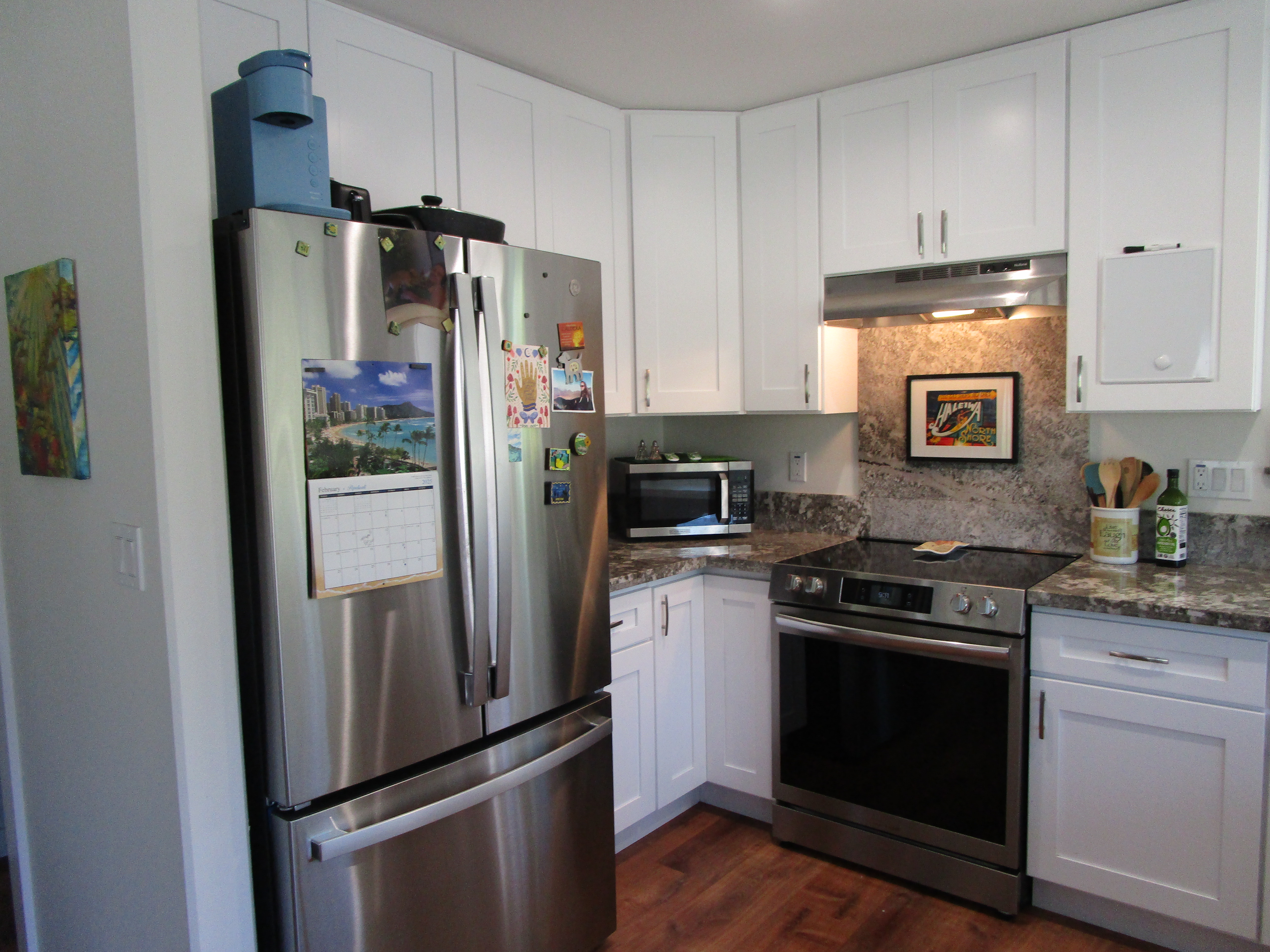 1 Kokokahi Road Mountain View, HI 96771 - Photo 6 of 27 a kitchen with stainless steel appliances a refrigerator stove and microwave