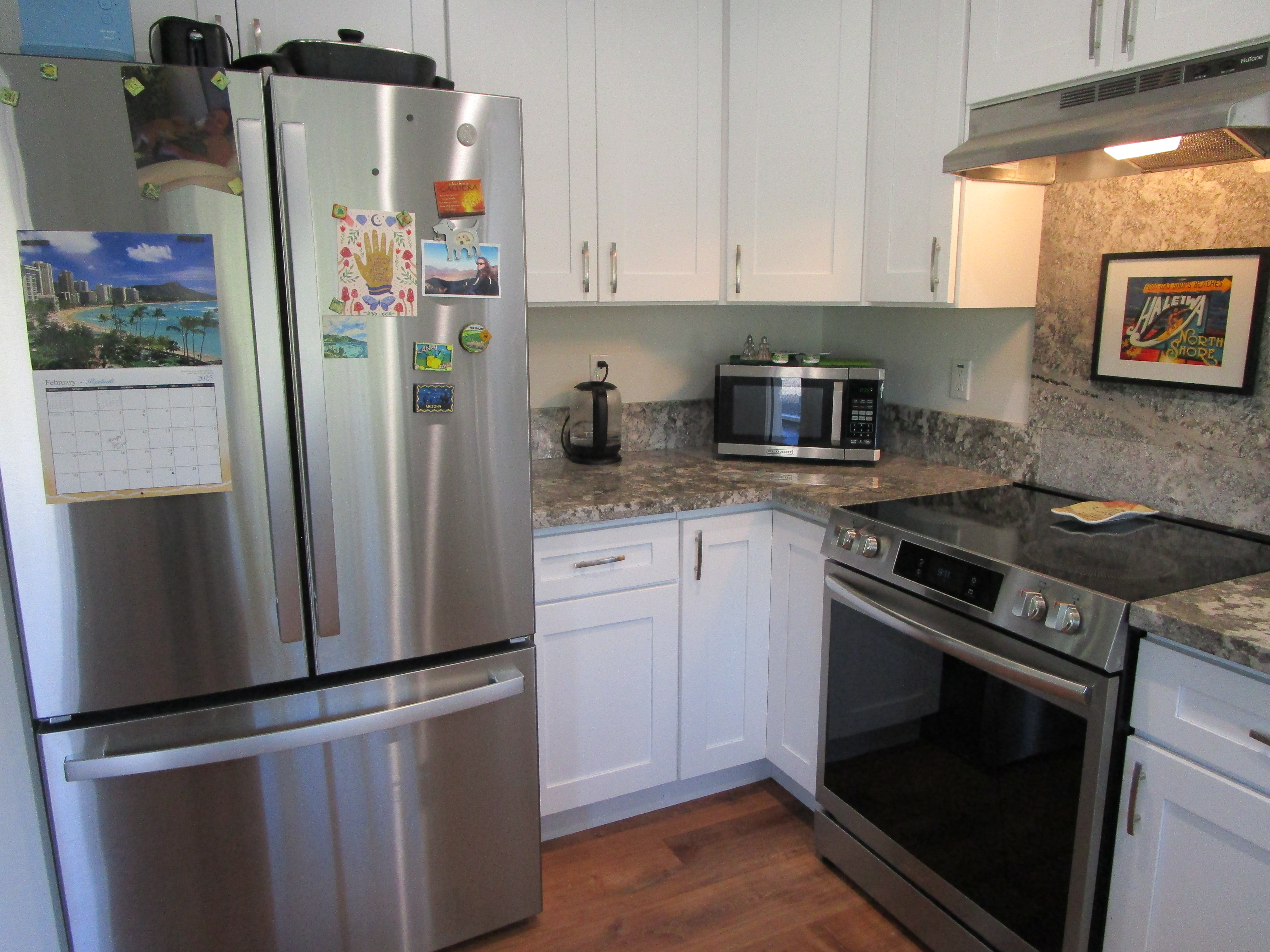 1 Kokokahi Road Mountain View, HI 96771 - Photo 7 of 27 a kitchen with stainless steel appliances a refrigerator stove and microwave