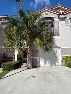 a view of a house with a tree and a yard