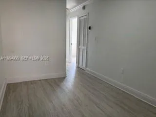 an empty room with wooden floor