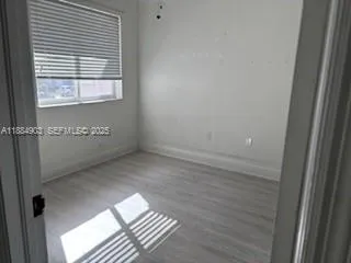 a view of an empty room with a window