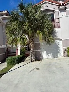 a couple of palm trees in front of house