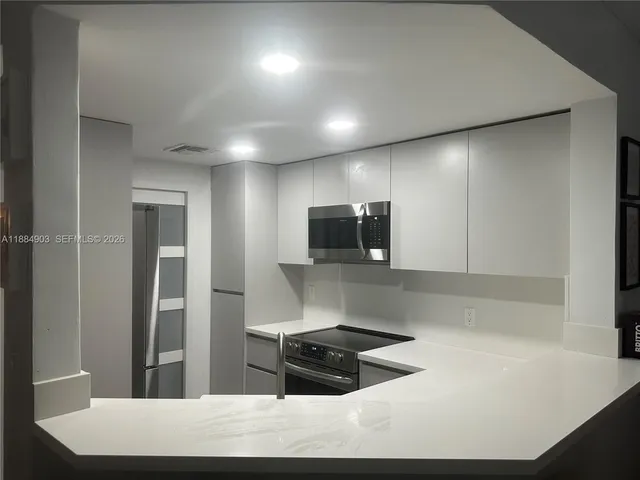 a kitchen with a sink and a stove top oven