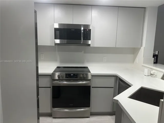 a kitchen with a stove and a microwave