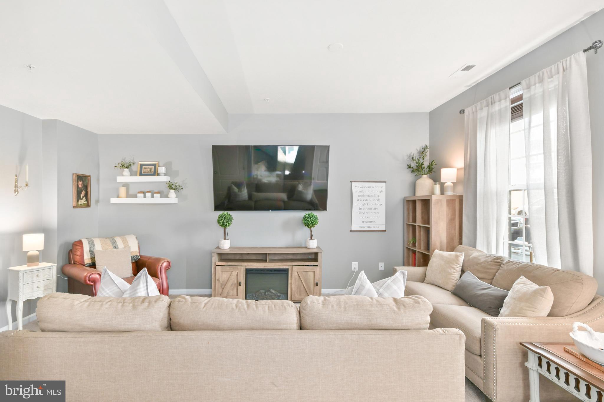 2709 Osprey Way North Frederick, MD 21701 - Photo 18 of 64 a living room with furniture a flat screen tv and a fireplace