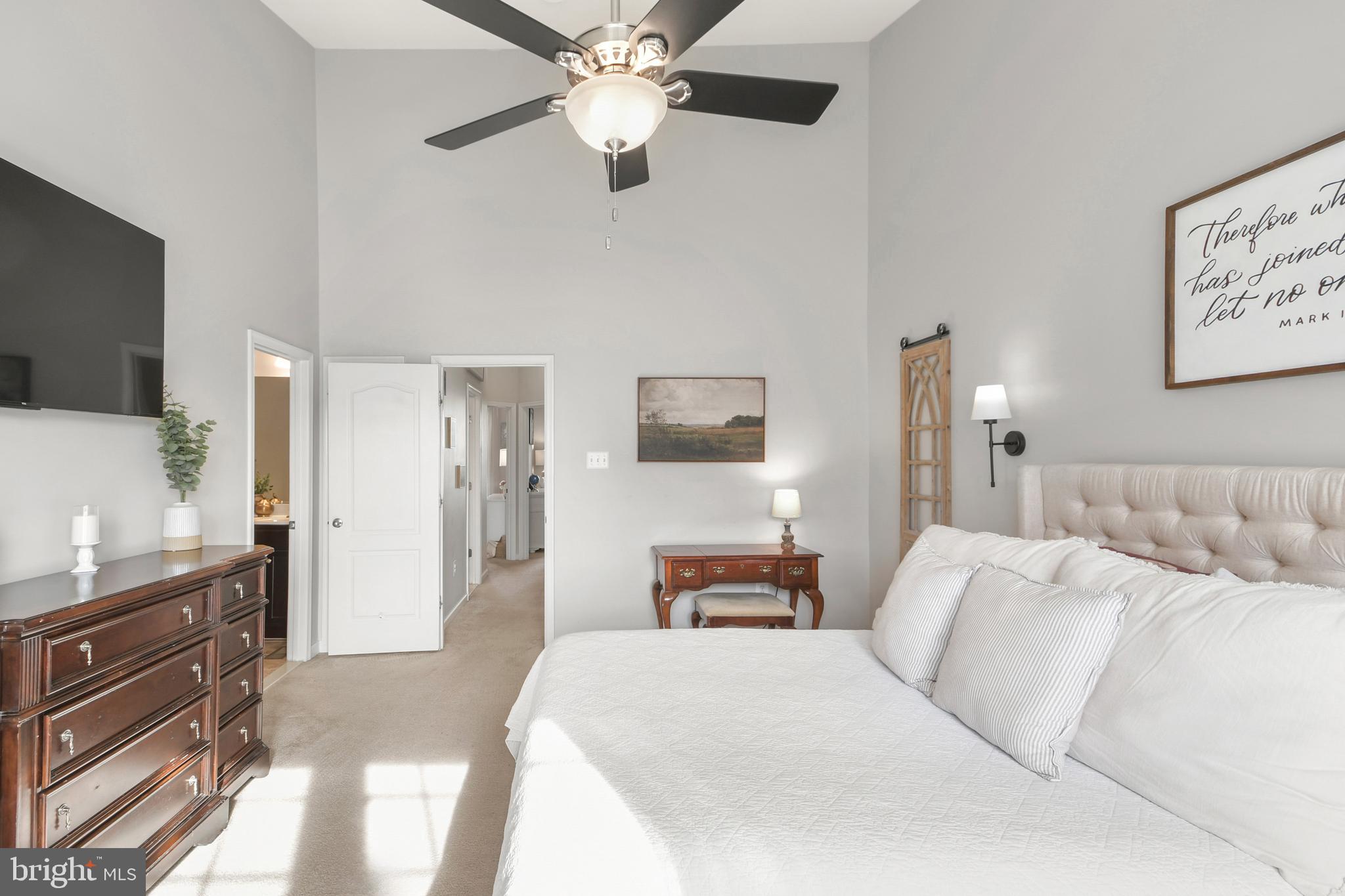 2709 Osprey Way North Frederick, MD 21701 - Photo 44 of 64 a bedroom with a large bed and a flat tv screen on a dresser