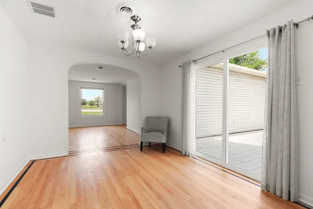 a view of a livingroom with furniture window and wooden floor