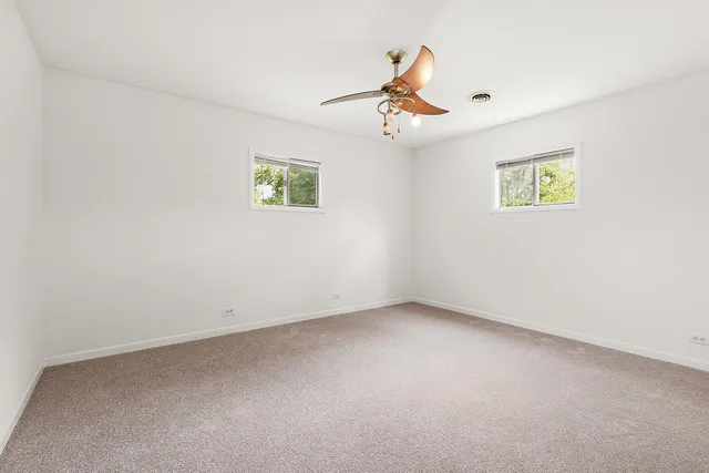 a view of room with ceiling fan and window