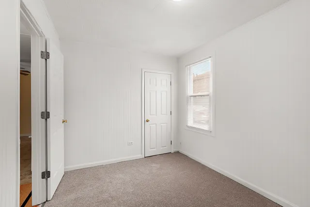 a view of an empty room with windows