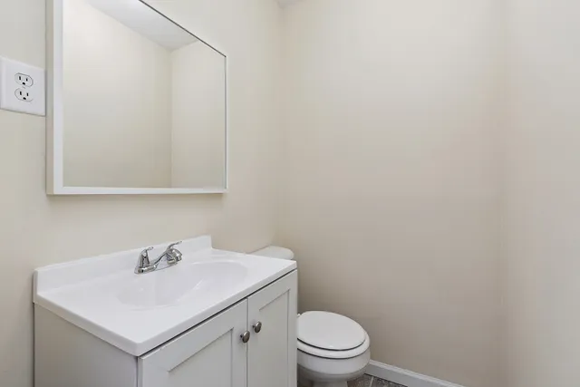 a bathroom with a sink a toilet and mirror