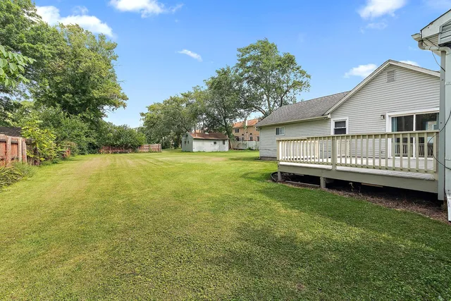 a view of a house with garden and deck