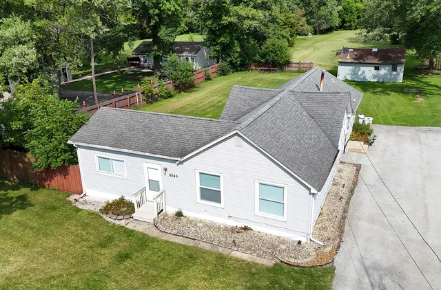 an aerial view of a house with a yard