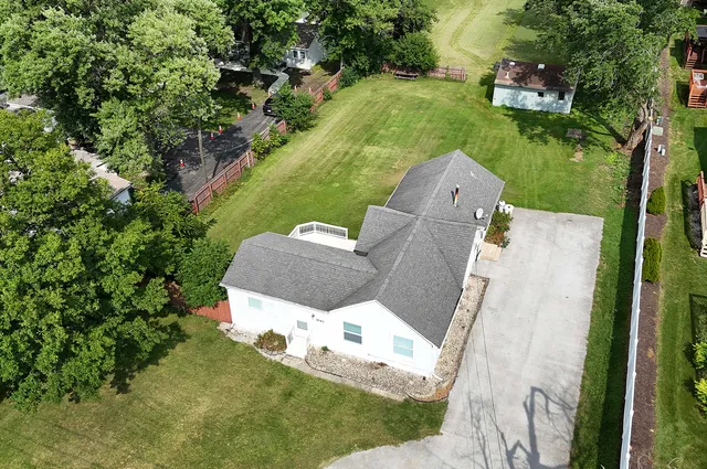 an aerial view of a house with garden space and street view
