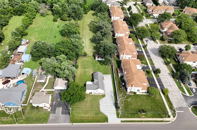 an aerial view of residential houses with outdoor space