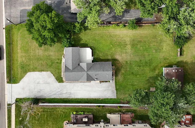 an aerial view of a house with a garden and swimming pool