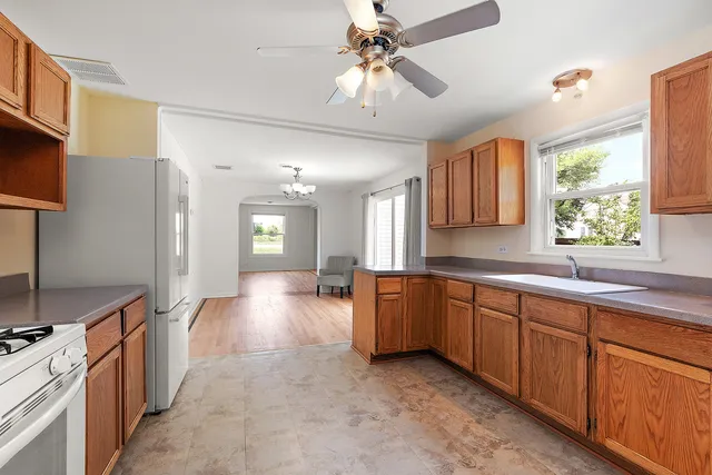 a large kitchen with cabinets a sink and appliances