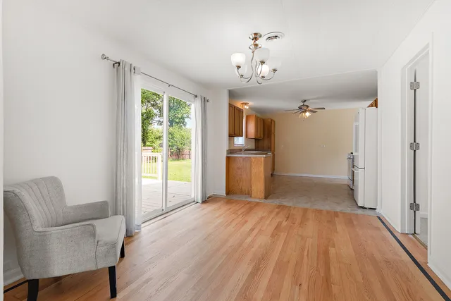 a view of a livingroom with a furniture wooden floor and a window