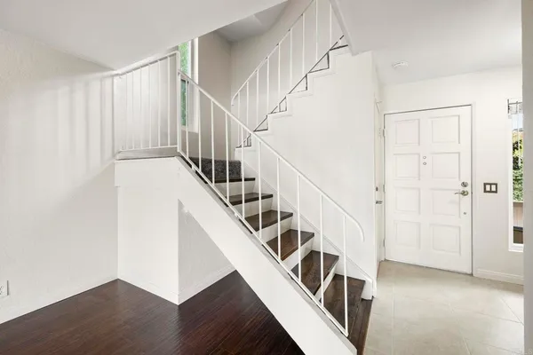 a view of entryway and hall with wooden floor