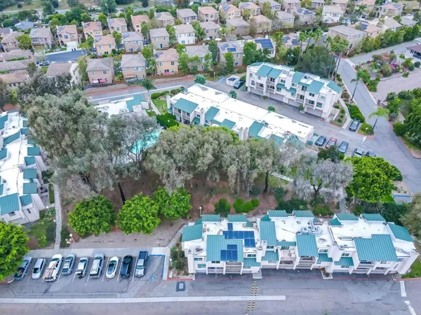 an aerial view of a house with garden space and street view