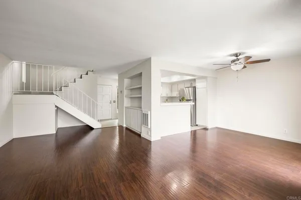 a view of an empty room with wooden floor