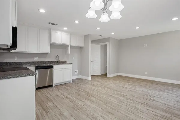 a view of a kitchen with a sink cabinets and stainless steel appliances