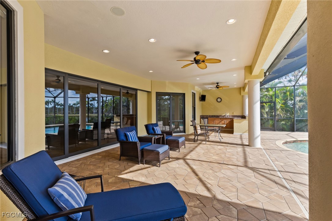 6057 Calusa Rdg Trail Bokeelia, FL 33922 - Photo 26 of 45 a living room with furniture a floor to ceiling window and potted plant
