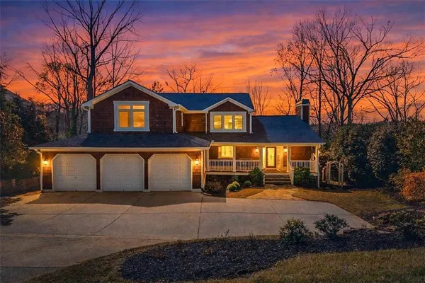 a view of a white house with a yard covered with snow in front of house