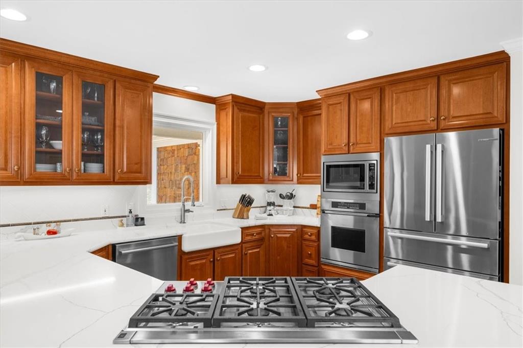 9230 Four Mile Creek Road Gainesville, GA 30506 - Photo 16 of 67 a kitchen with stainless steel appliances granite countertop a sink stove refrigerator and cabinets