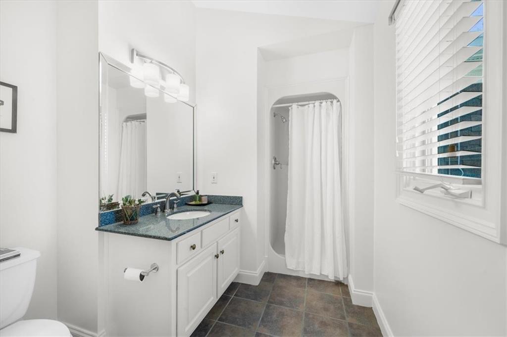 9230 Four Mile Creek Road Gainesville, GA 30506 - Photo 30 of 67 a bathroom with a granite countertop sink and a mirror