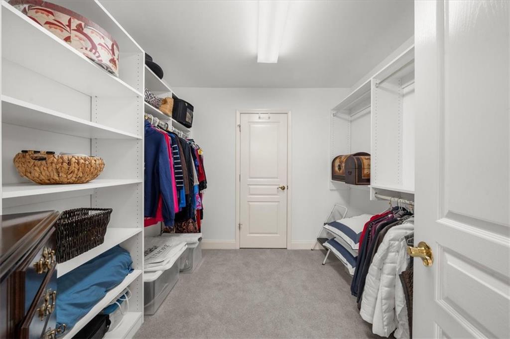 9230 Four Mile Creek Road Gainesville, GA 30506 - Photo 39 of 67 a view of walk in closet with clothes and shoes