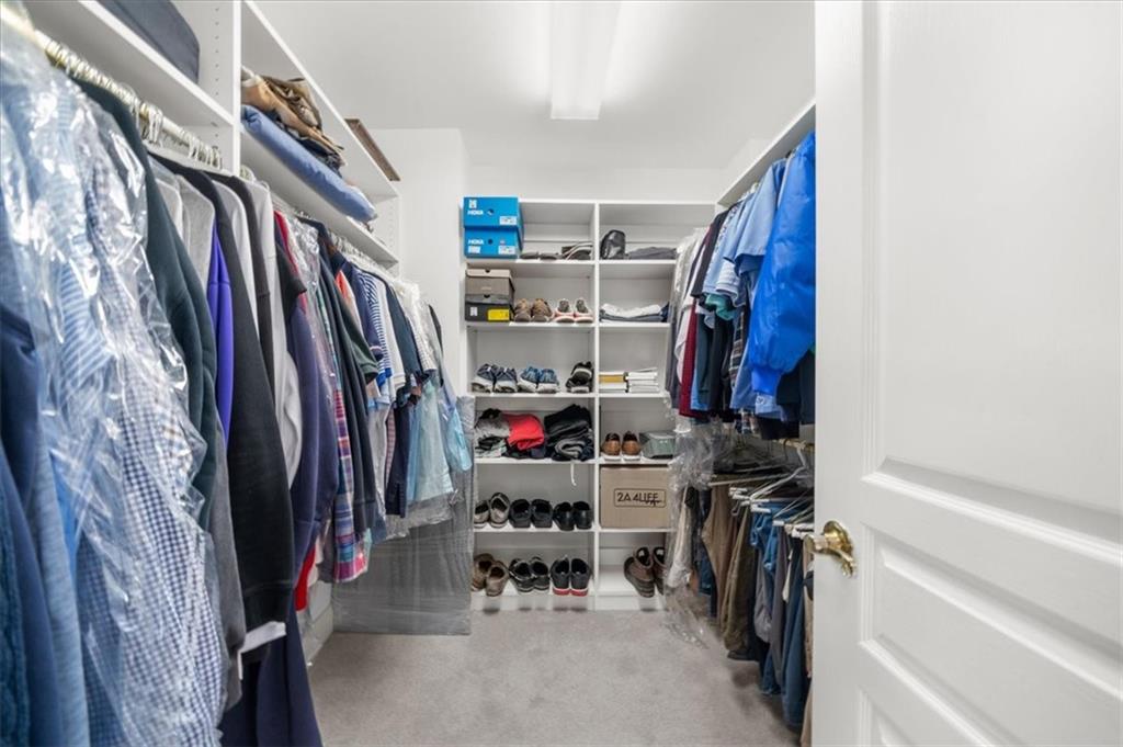 9230 Four Mile Creek Road Gainesville, GA 30506 - Photo 40 of 67 a view of walk in closet with clothes and shoes
