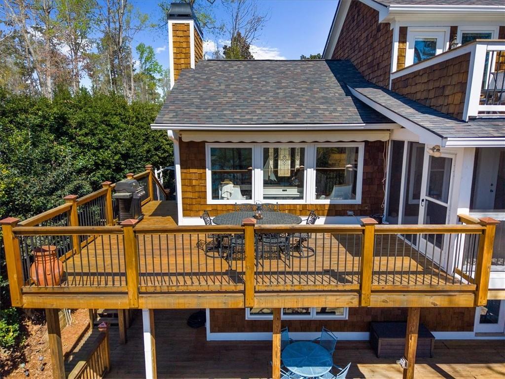9230 Four Mile Creek Road Gainesville, GA 30506 - Photo 45 of 67 a view of a house with large windows and a wooden deck
