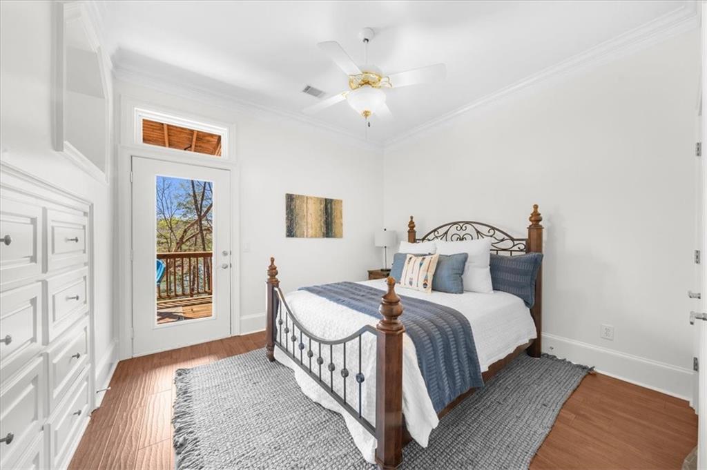 9230 Four Mile Creek Road Gainesville, GA 30506 - Photo 49 of 67 a bedroom with a bed and a chandelier