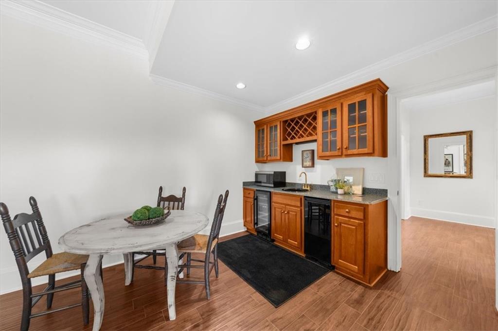 9230 Four Mile Creek Road Gainesville, GA 30506 - Photo 50 of 67 a living room with stainless steel appliances kitchen island granite countertop a table chairs and wooden floor