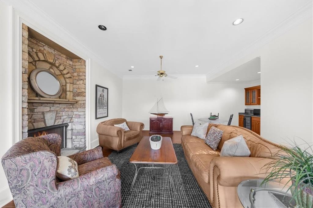 9230 Four Mile Creek Road Gainesville, GA 30506 - Photo 52 of 67 a living room with furniture a fireplace and a flat screen tv