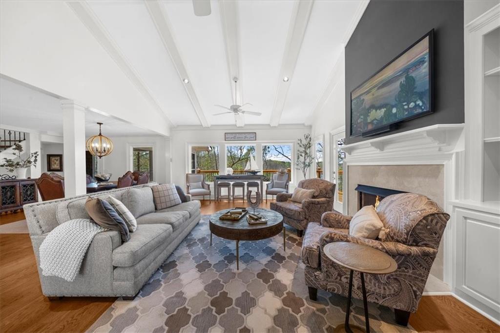 9230 Four Mile Creek Road Gainesville, GA 30506 - Photo 9 of 67 a living room with furniture a fireplace and wall paintings