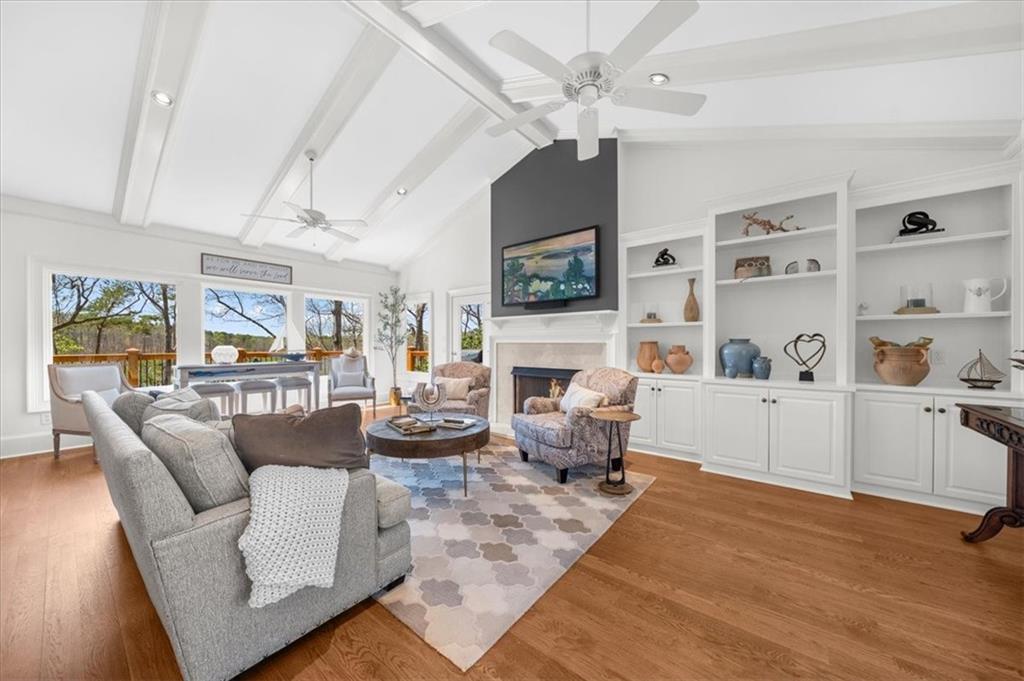 9230 Four Mile Creek Road Gainesville, GA 30506 - Photo 10 of 67 a living room with furniture a fireplace and a flat screen tv