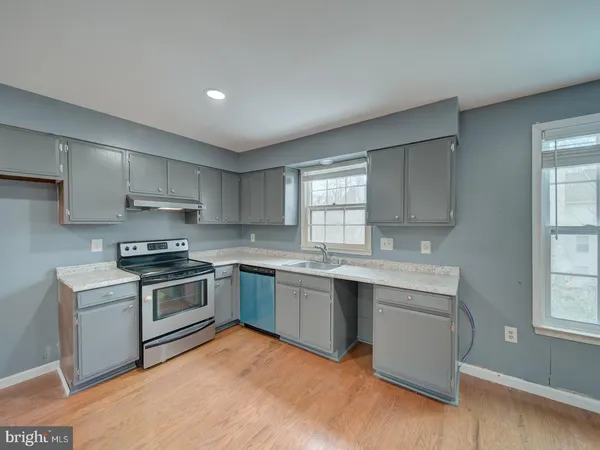 a kitchen with stainless steel appliances granite countertop a stove and a sink