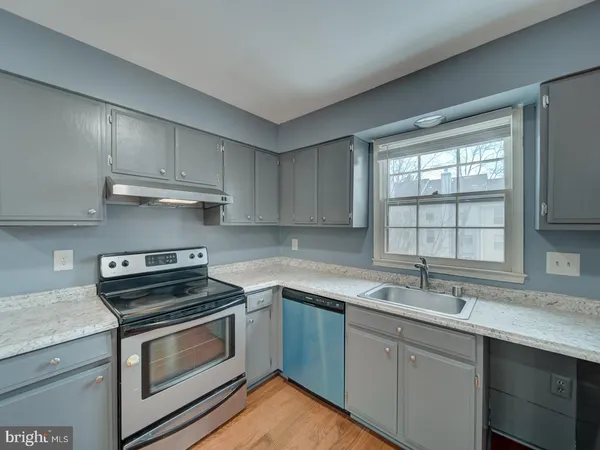 a kitchen with a sink stove and cabinets