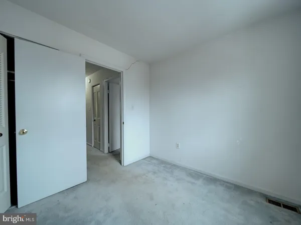 a view of an empty room and closet area