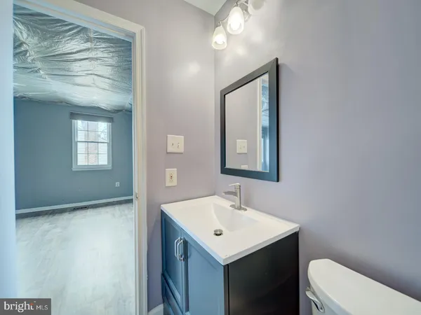 a bathroom with a sink mirror and toilet