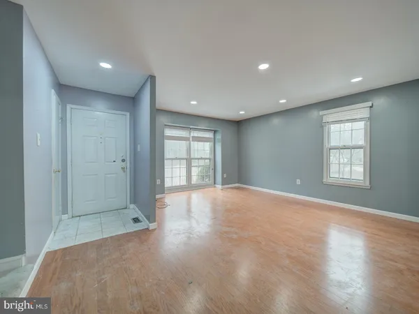 an empty room with windows and closet