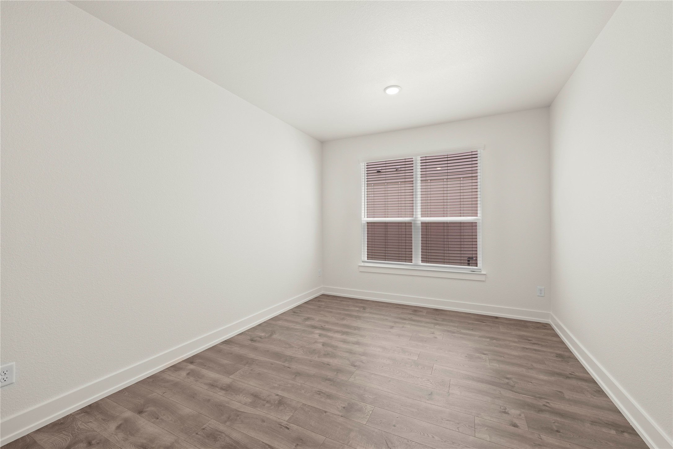 564 Gus Loop Georgetown, TX 78626 - Photo 12 of 32 an empty room with wooden floor and windows