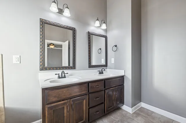 a spacious bathroom with a double vanity sink double and mirror